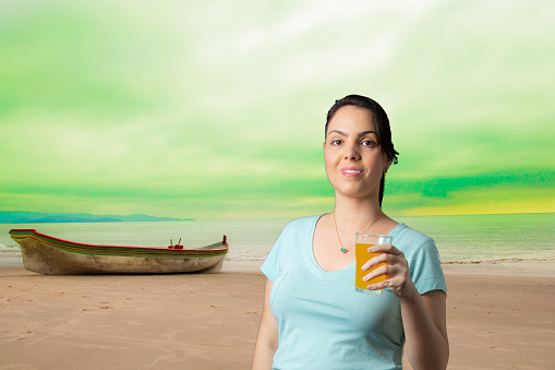 portrait of woman drinking juice with virtual background canoe on the beach with aurora borealis style sky