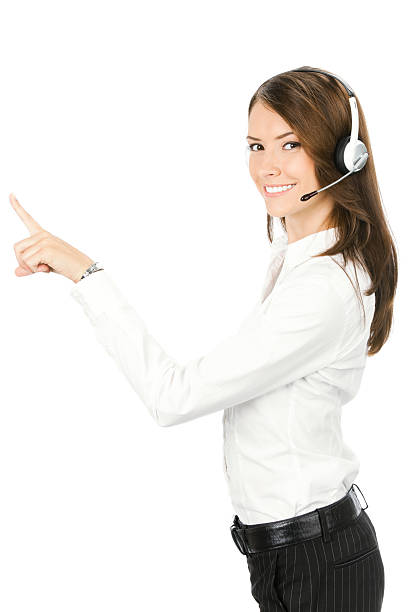 Customer support phone operator in headset pointing at something stock photo