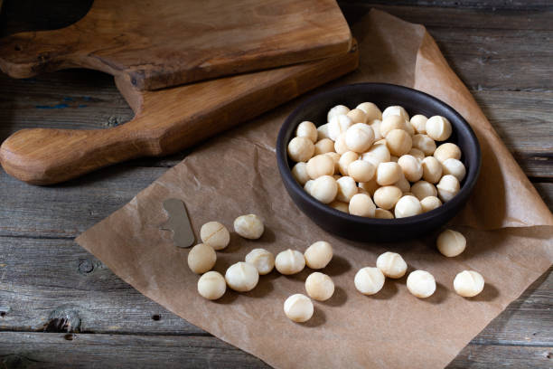 istock Macadamia nuts in wooden bowl on rustic  background 1222637267