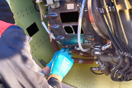 Aircraft engineer repairing and maintaining an airplane jet engine