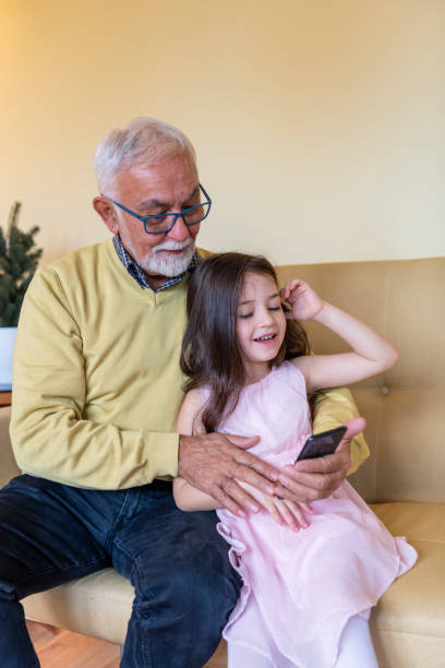 istock Generation Gap. A Girl is Teaching Grandpa to Use a Tablet. 1222640283