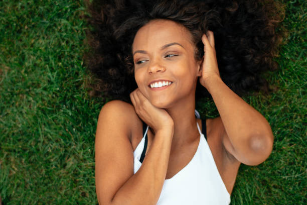 istock Young african girl lying on grass. 1222641724