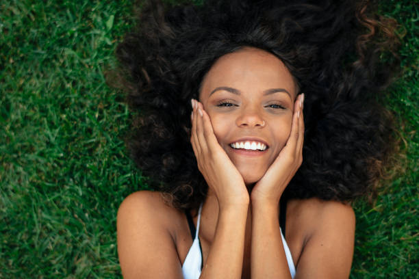 istock Young african girl lying on grass. 1222641745