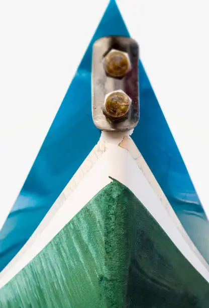 Photo of Blue and green hull of sail boat, front view