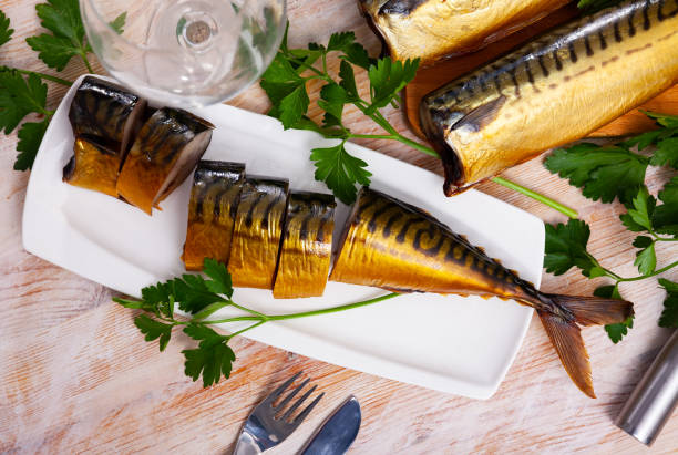 istock Sliced appetizing smoked mackerel with parsley closeup 1222642951