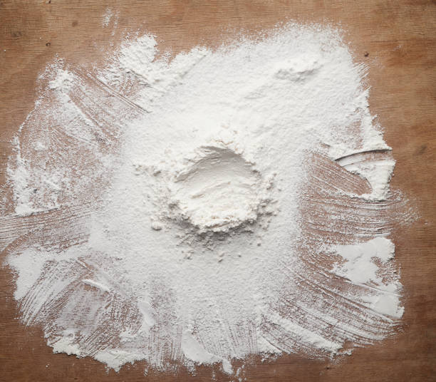 istock white wheat flour scattered on a brown wooden table 1222643134