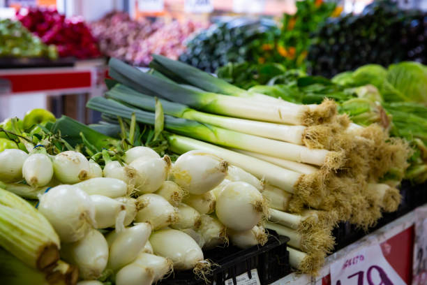 istock Green onion and leek on market counter 1222643298
