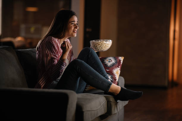 istock Young woman watching tv at home. 1222643547