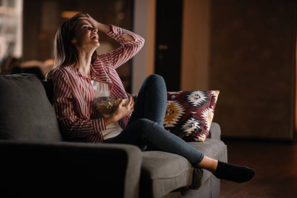 istock Young woman watching tv at home. 1222643573