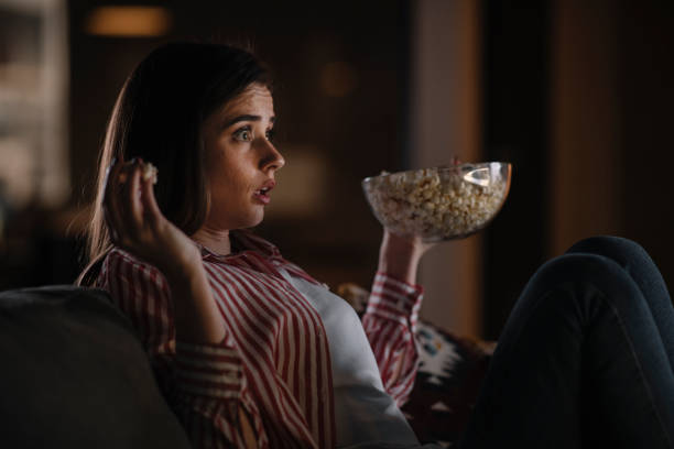 istock Young woman watching tv at home. 1222643575