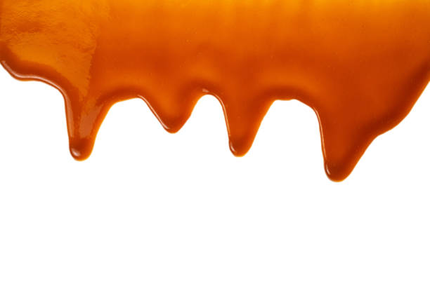 istock Background of flowing caramel sauce isolated on white. 1222644644