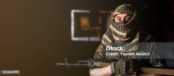 Arab Male Soldier In A Headdress From The National Keffiyeh With Weapons In His Hands Muslim Man With Guns On Black Stock Photo - Download Image Now