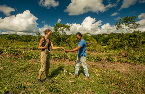 istock Two young adults clear land for planting 1222648229