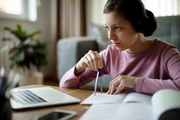 adolescente con auriculares estudiando en casa - drawing compass drawing circle technology fotografías e imágenes de stock