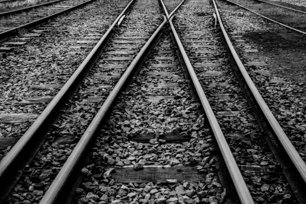 istock Railway rails that run through grooved sleepers buried under cobblestones 1222649468