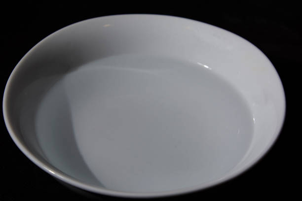 istock White bowl filled with water on black background 1222649498