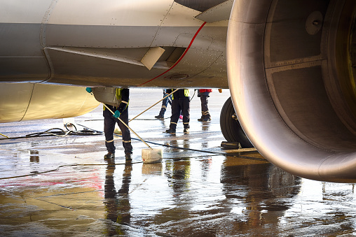 Airplane technicians washing the plane