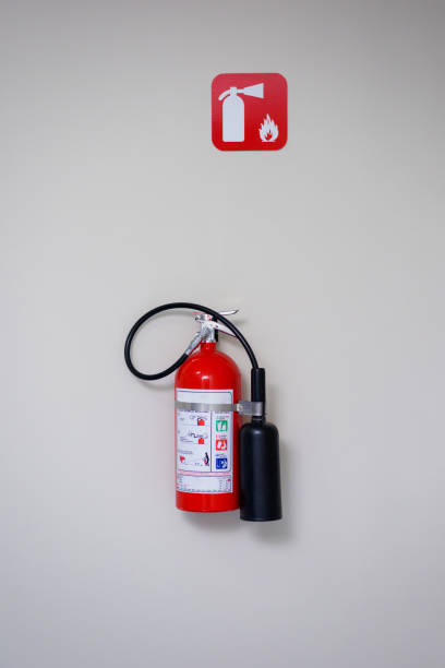 istock Fire extinguisher and fire department sign on a white wall. 1222650784