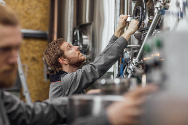 istock Beer Production Process: Workers Checking Storage Tanks at a Craft Brewery 1222651894