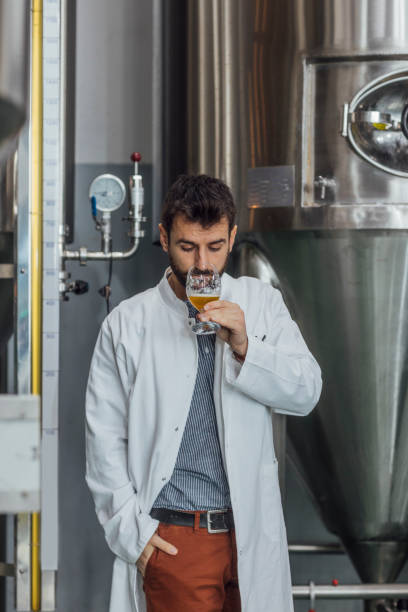 istock Quality Control at a Craft Brewery: Engineer Checking the Smell of Beer 1222651912