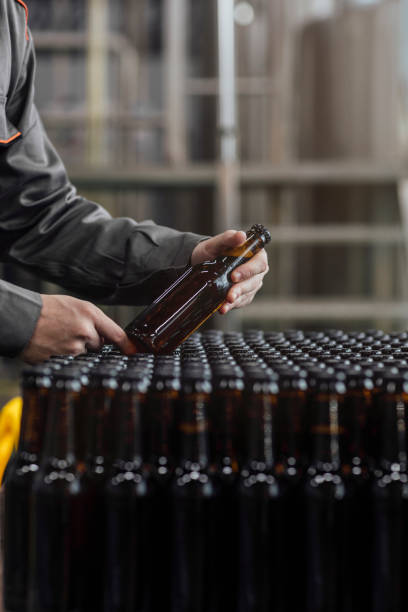 istock Lager Making Process: Unrecognizable Factory Workers Holding Bottled Beer 1222651926