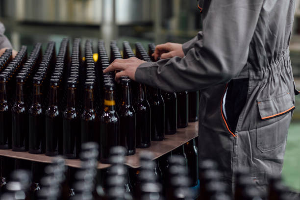 istock Lager Making Process: Unrecognizable Factory Workers Holding Bottled Craft Beer 1222651929
