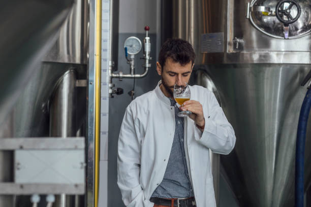 istock Quality Control at a Craft Brewery: Engineer Checking the Smell of Beer 1222651946
