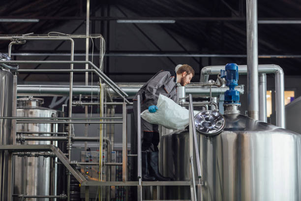 istock Beer Factory Worker Loading the Hops Crop into a Tank 1222651960