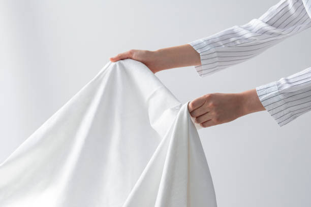 Hands of an Unrecognizable Woman Holding a Clean Bed Sheet
