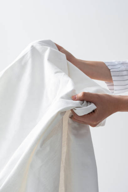 istock Hands of an Unrecognizable Woman Holding a Clean Bed Sheet 1222652375