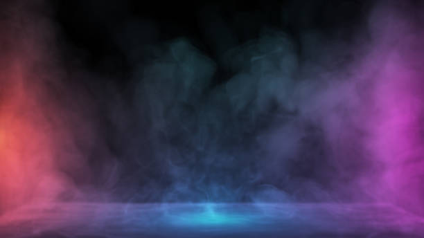 Liquid smoke falling down on surface in colored lights. Dry ice drop spreading on floor stock photo
