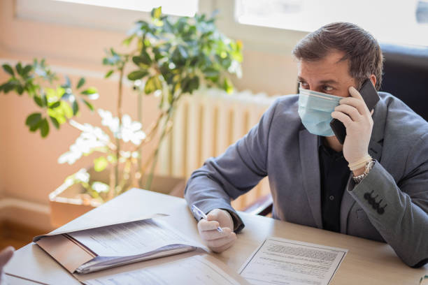 istock Mature businessman using his phone in the office 1222655918