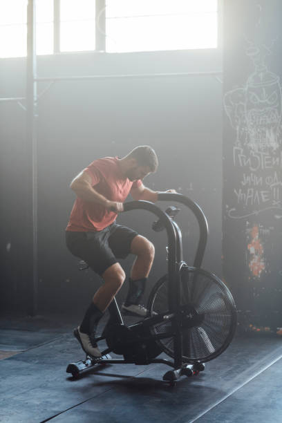 istock Handsome Man Doing Exercise on a Gym Stationary Bike, gym Concept 1222657351