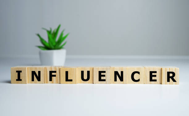 istock focus on wooden blocks with letters making Influencer text. 1222657508