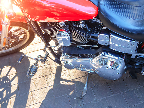 Closeup dawn part motorcycle engine side reflective metal on street