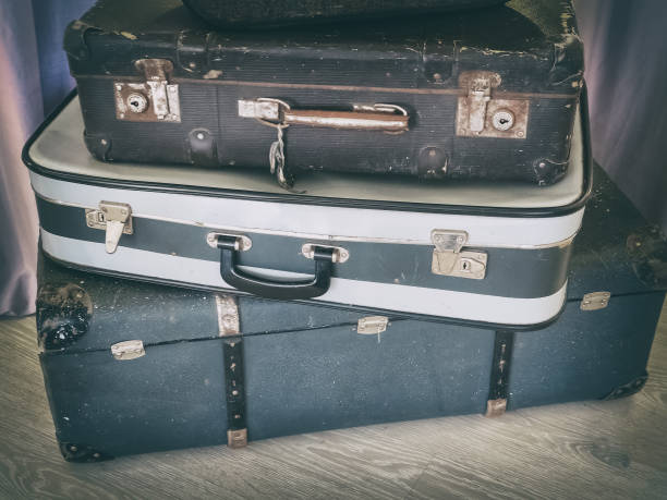 istock Three old suitcases lie on top of each other. Artistic effect 1222660283