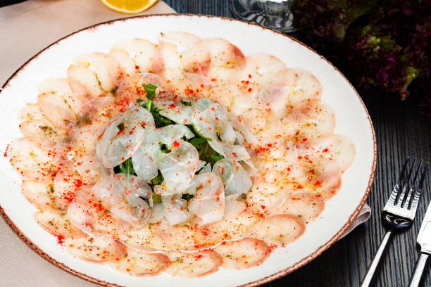 istock Dorado fish carpaccio served with arugula salad on white plate. 1222662489