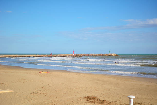 istock Group of surfers on the beach on a summer day 1222664779