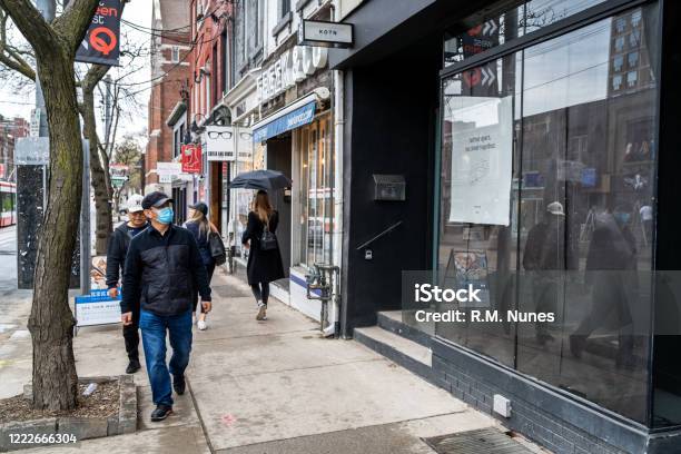 Toronto Locals Wearing Face Masks On The Streets During Coronavirus Pandemic Ontario Canada Stock Photo - Download Image Now