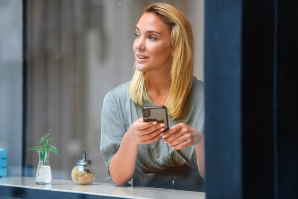 istock Relaxed Young Argentine Woman Texting in Cafe Window 1222667952