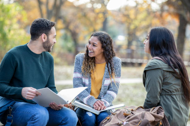 istock Adults university students sitting together and holding books 1222667992