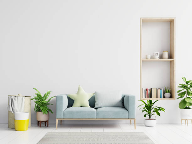 istock Empty living room with blue sofa, plants and table on empty white wall background. 1222669586