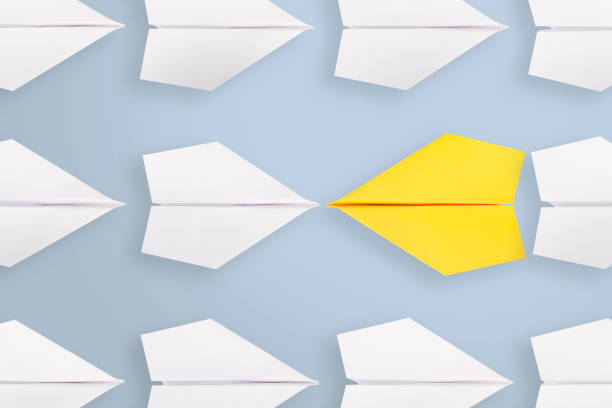 istock Change concepts with yellow paper airplane leading among white 1222671189