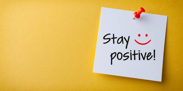 istock White Sticky Note With Stay Positive And Red Push Pin On Yellow Background 1222671237