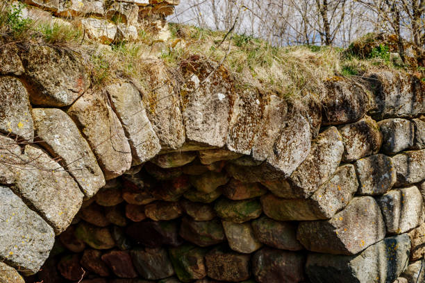 istock Ancient stone bridge over the river against the blue sky. Vintage Romanesque architecture. 1222671968