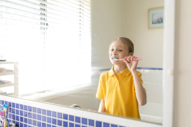 istock Young School Girl Brushing Teeth 1222686636