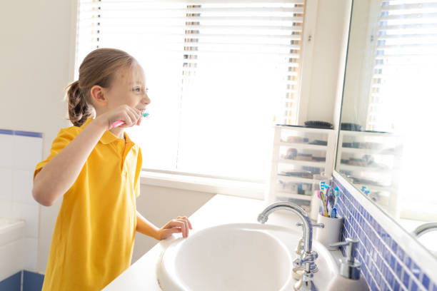 istock Young School Girl Brushing Teeth 1222686709