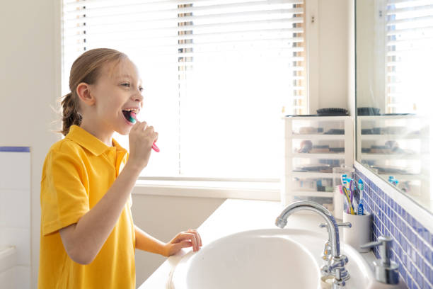 Young School Girl Brushing Teeth