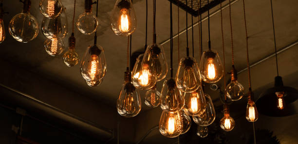 istock Beautiful vintage luxury light bulb hanging decor glowing in dark. 1222687475