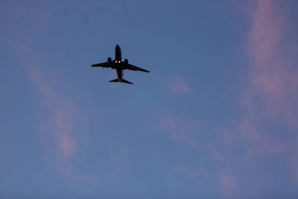 istock Airplane about to land during the sunset 1222687496